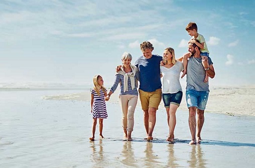 family-walking-on-the-beach